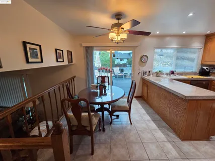 a view of a dining room with furniture a chandelier and wooden floor