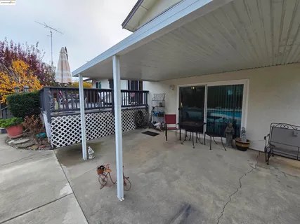 a balcony with furniture and a potted plant