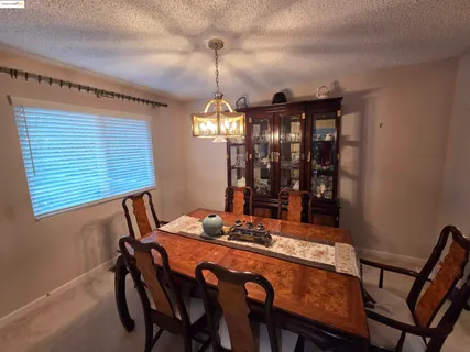 a view of a dining room with furniture and window