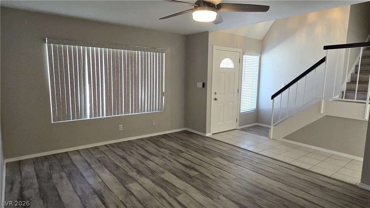 3849 Reflection Way Las Vegas, NV 89147 - Photo 5 of 25 This naturally illuminated living room features durable laminate flooring and direct entry to the home's primary staircase.