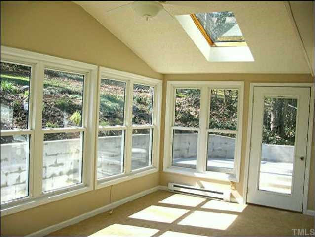 4113 Weaver Drive Raleigh, NC 27612 - Photo 5 of 8 A light-filled sunroom with ceramic tile floors and skylights Other