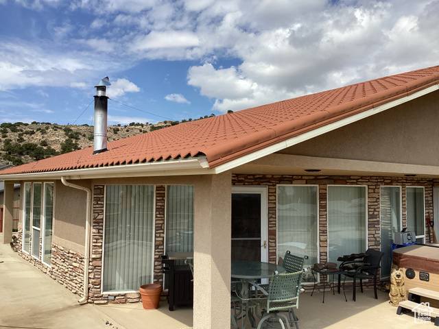 3 Red Circle, Unit 19 Manila, UT 84046 - Photo 8 of 29 Rear view of property with stone siding, stucco siding, and a patio