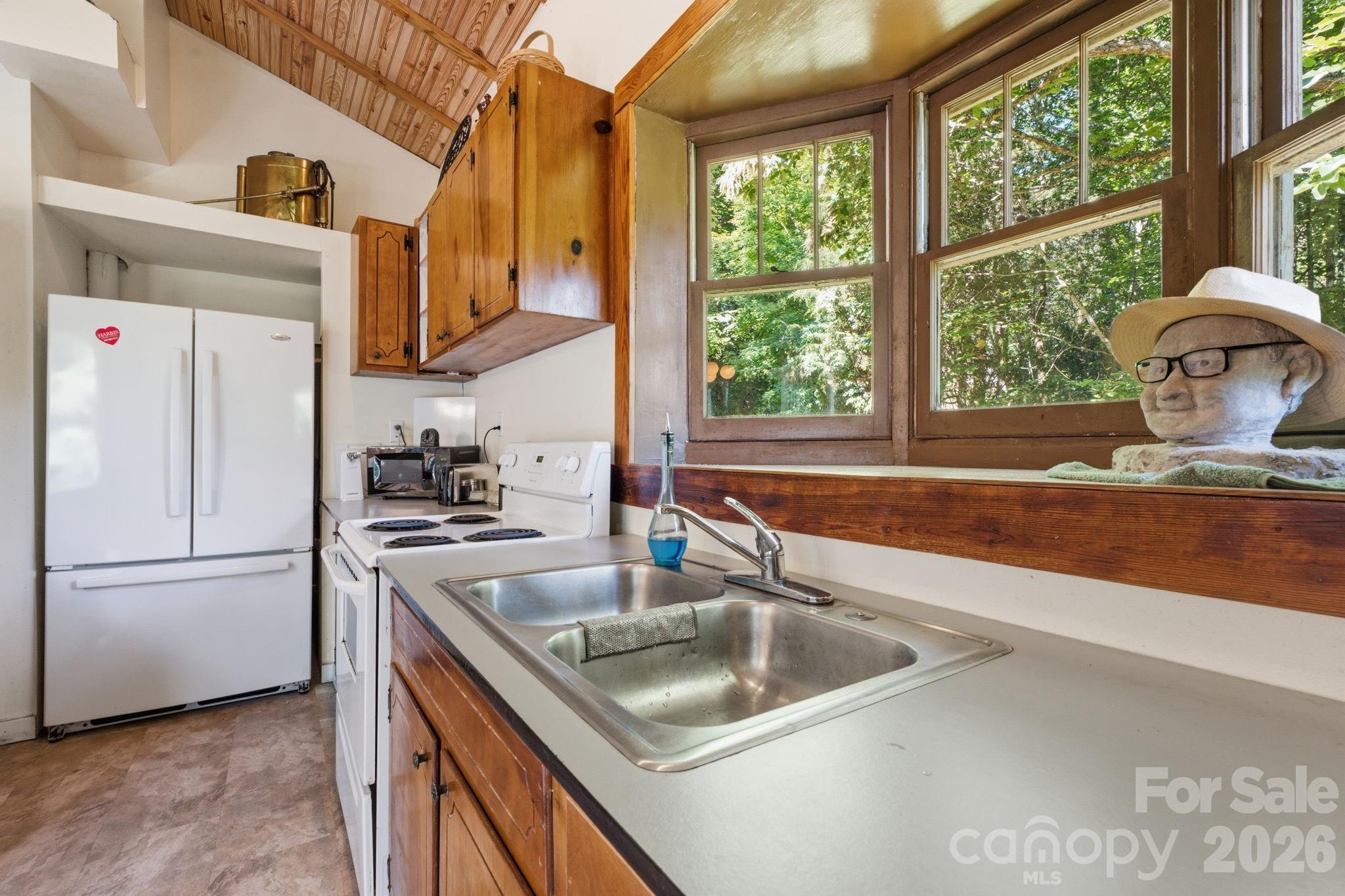 583 Dark Ridge Road Sylva, NC 28779 - Photo 17 of 48 a kitchen with stainless steel appliances granite countertop a sink and a refrigerator