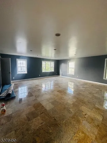 a view of empty room with window and fireplace