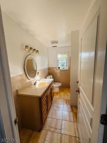 a bathroom with a washing machine and sink