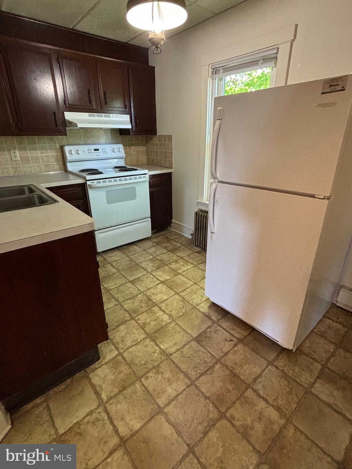 976 West Main Street, Unit 2 New Holland, PA 17557 - Photo 7 of 12 a kitchen with stainless steel appliances granite countertop a refrigerator a stove a sink and a microwave