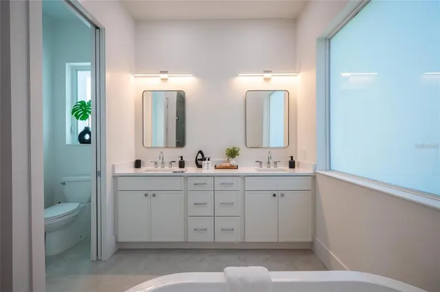 a bedroom with a balcony a bed and a view of balcony