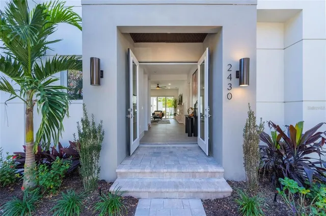 a kitchen with stainless steel appliances granite countertop a sink a stove and a refrigerator