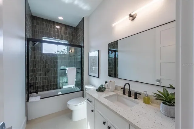 a view of a dining room with furniture a chandelier and wooden floor