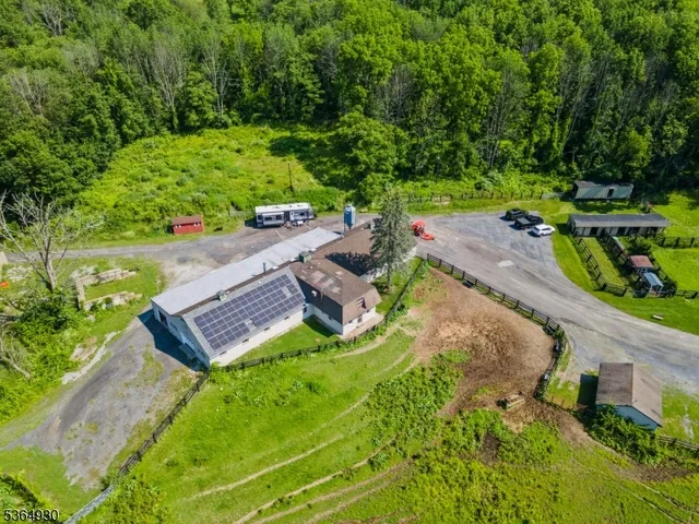 an aerial view of a house with garden space and street view