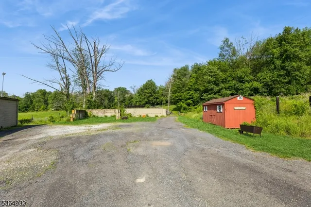 a view of house with outdoor space and garden