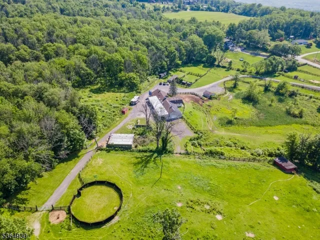 an aerial view of residential houses with outdoor space and swimming pool