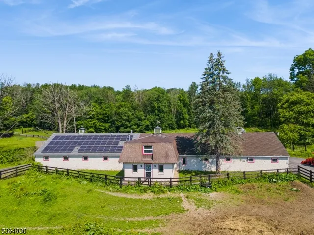 an aerial view of a house with garden space and street view