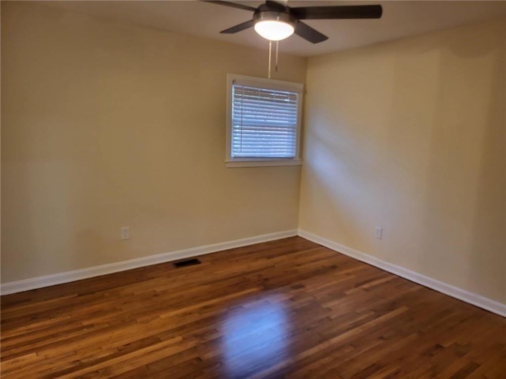 887 Bridgewater Street Southwest, Unit A Atlanta, GA 30310 - Photo 2 of 21 a view of an empty room with wooden floor and a window