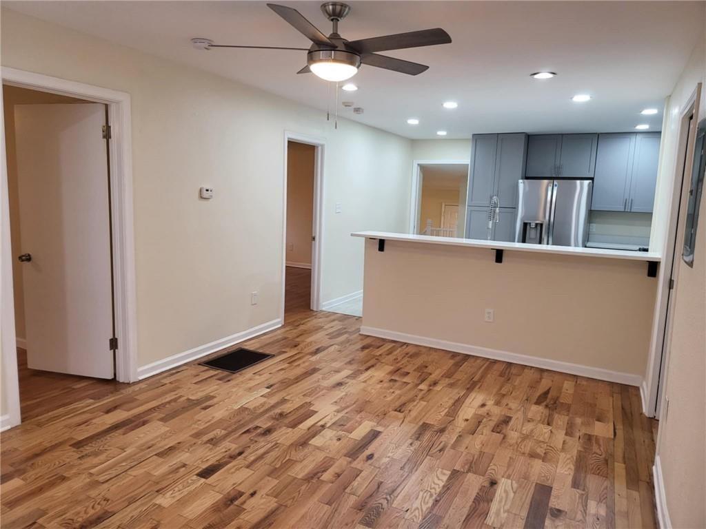 887 Bridgewater Street Southwest, Unit A Atlanta, GA 30310 - Photo 8 of 21 a view of an empty room with wooden floor and a ceiling fan