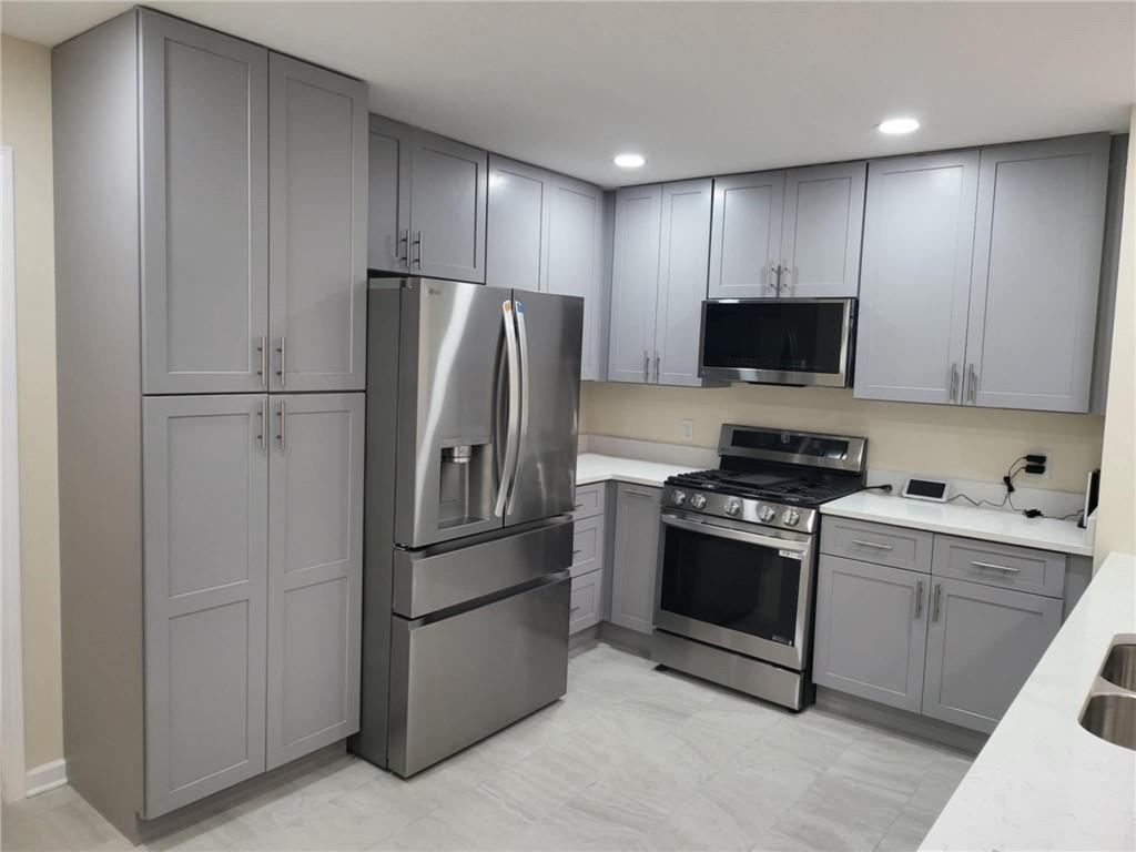887 Bridgewater Street Southwest, Unit A Atlanta, GA 30310 - Photo 9 of 21 a kitchen with stainless steel appliances a refrigerator stove and microwave