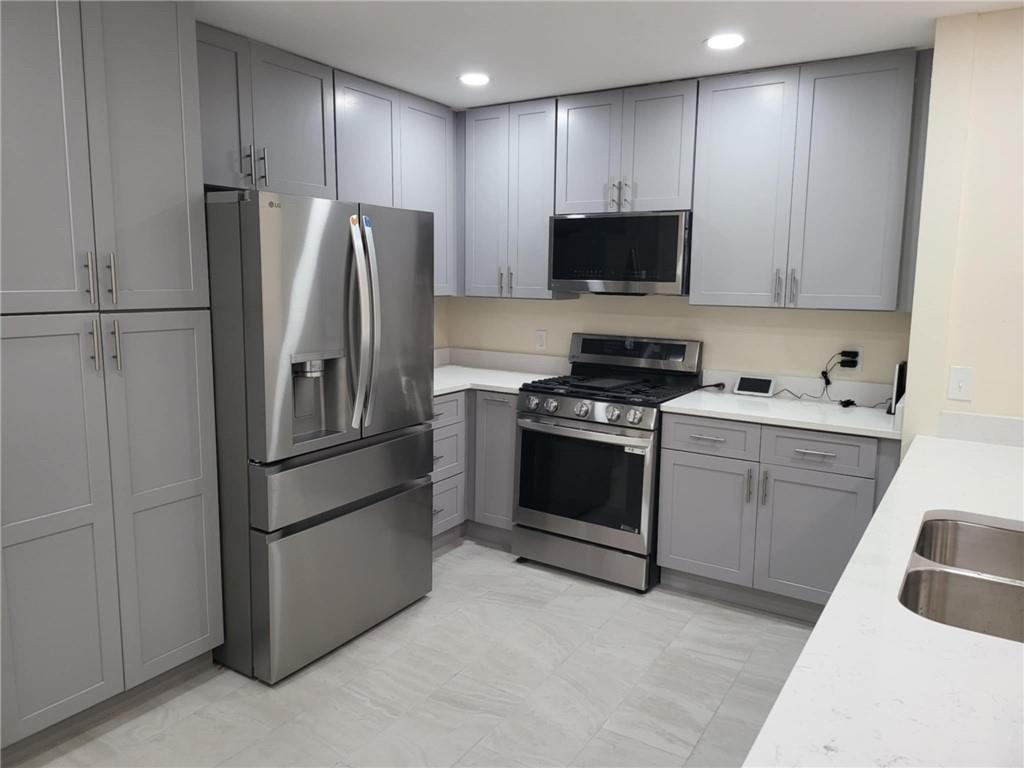 887 Bridgewater Street Southwest, Unit A Atlanta, GA 30310 - Photo 10 of 21 a kitchen with stainless steel appliances white cabinets and a refrigerator