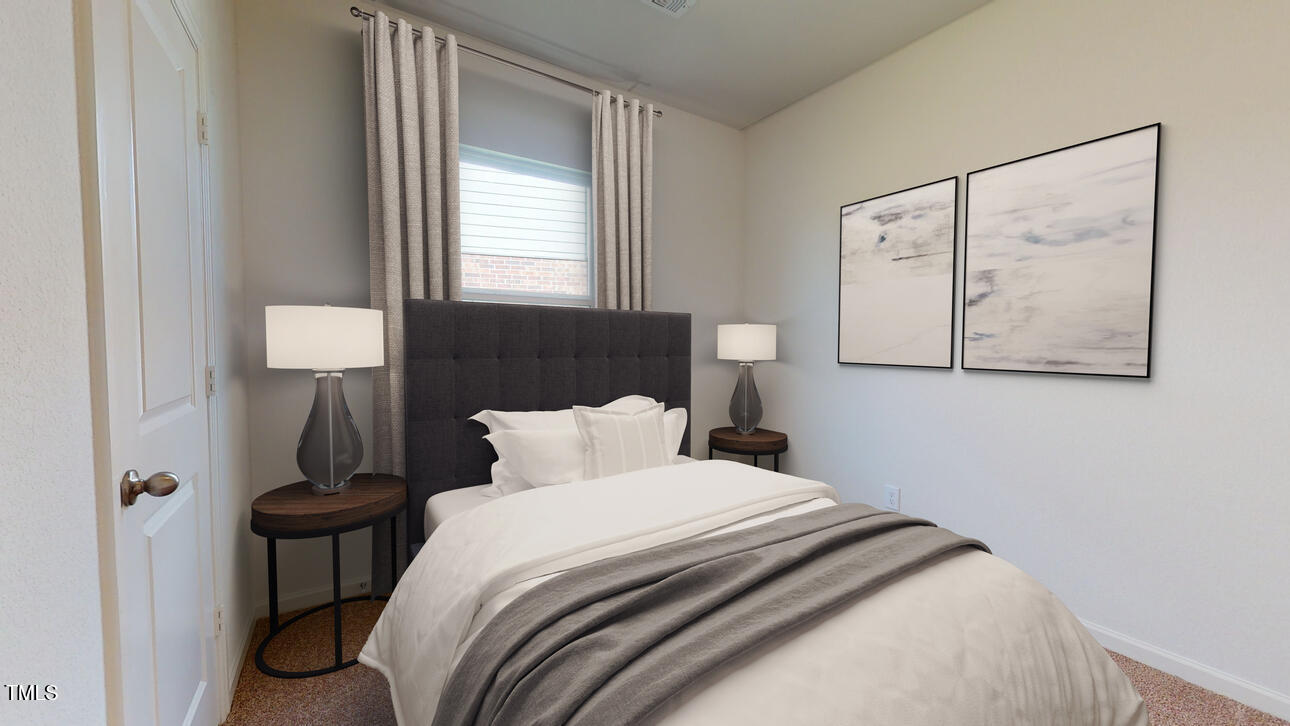 955 Embraer Way Spring Hope, NC 27882 - Photo 3 of 25 a bedroom with a bed and a window