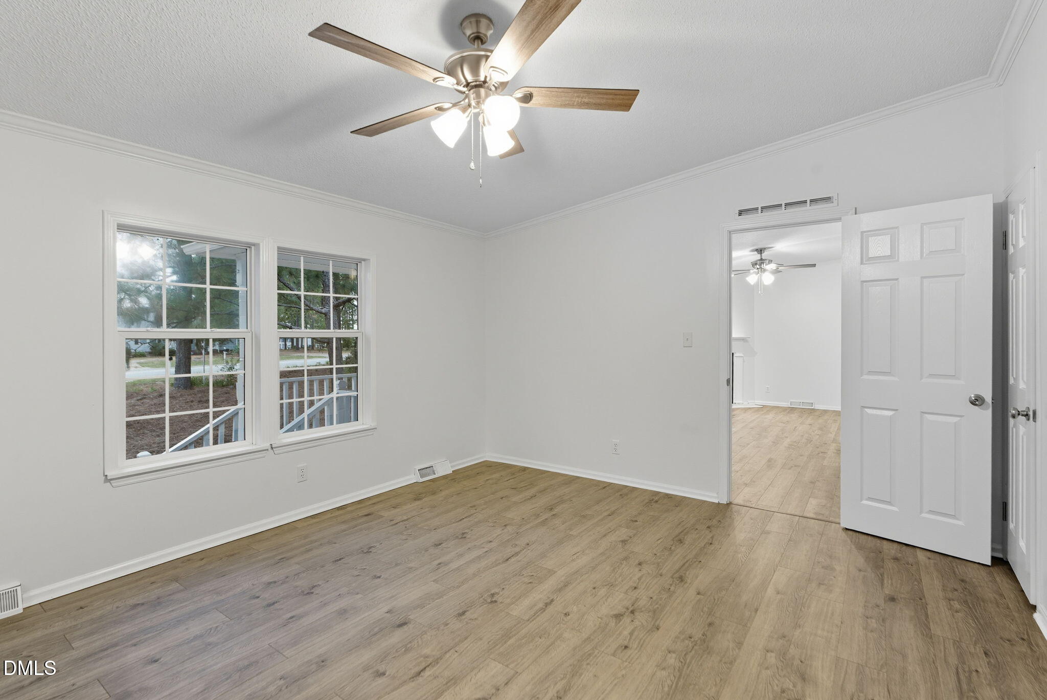 147 Ridge View Drive Cameron, NC 28326 - Photo 19 of 41 an empty room with wooden floor chandelier fan and windows