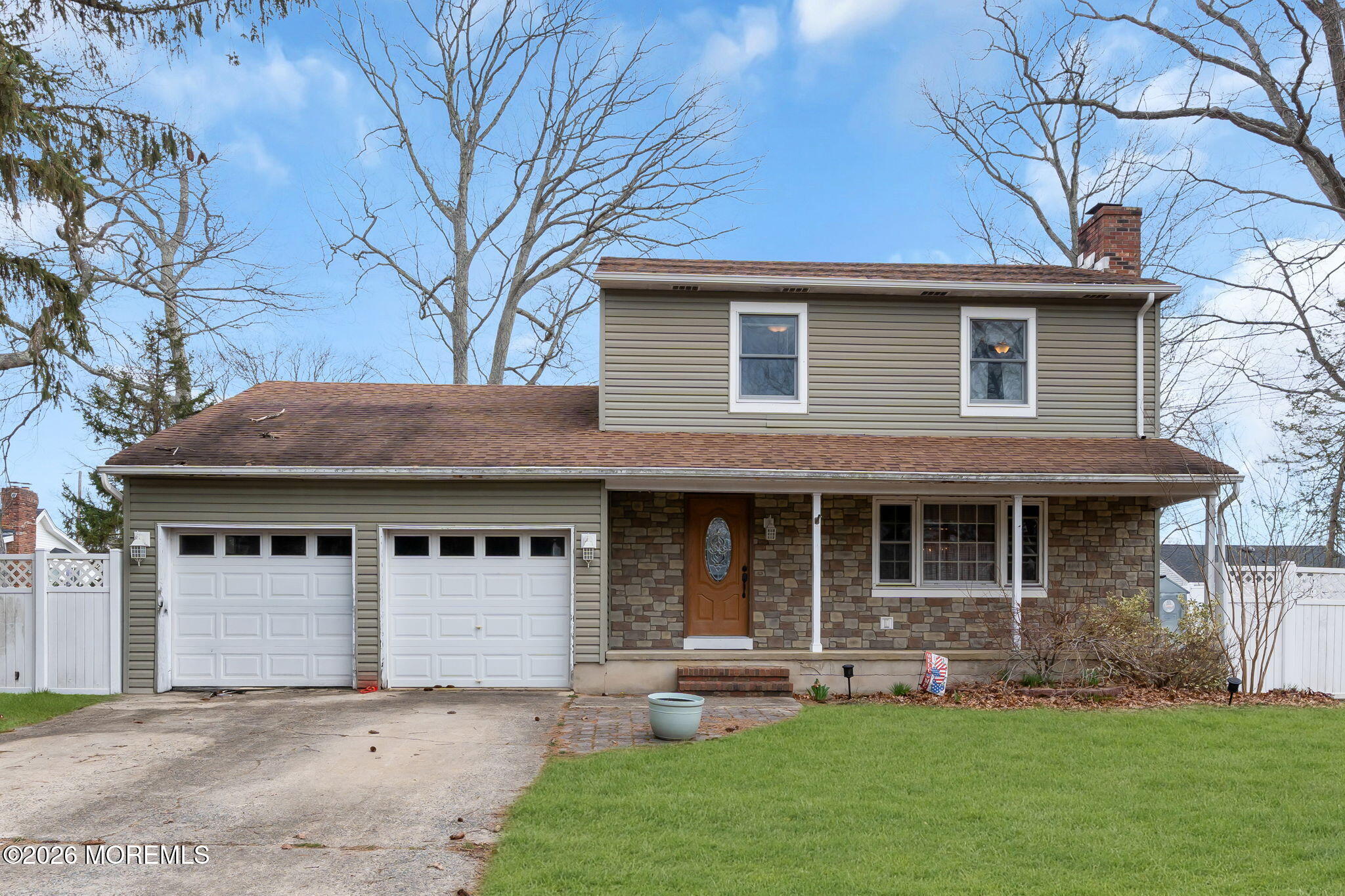 a front view of a house with a garden and yard