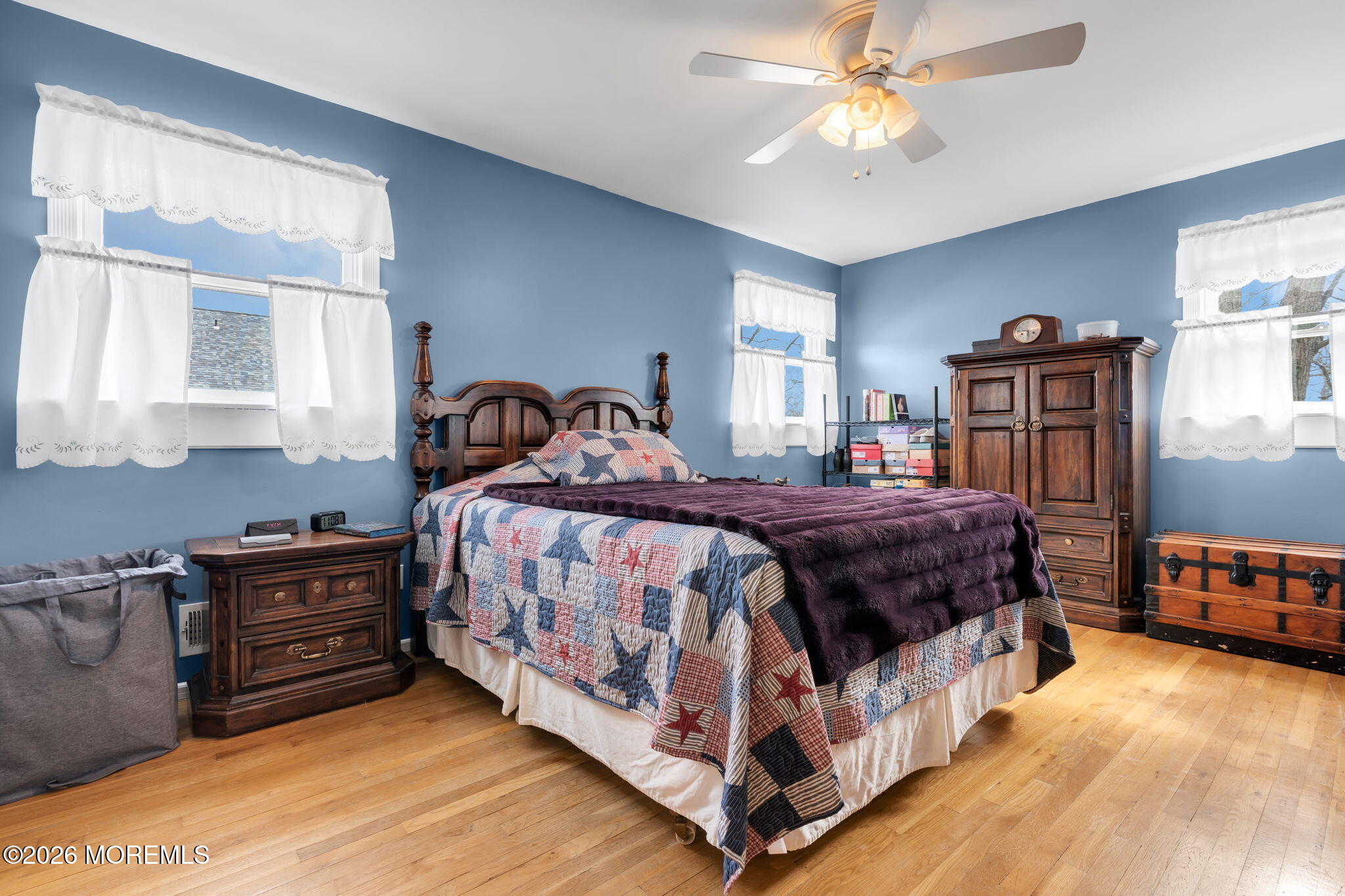 2908 Adams Street Wall, NJ 07719 - Photo 14 of 34 a bedroom with a bed a dresser and a chandelier