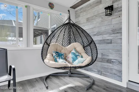 a picture of a room with a wooden floor and a table