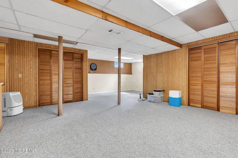 an empty room with furniture and a ceiling fan