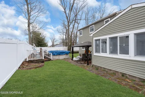 a view of a house with a yard and sitting area