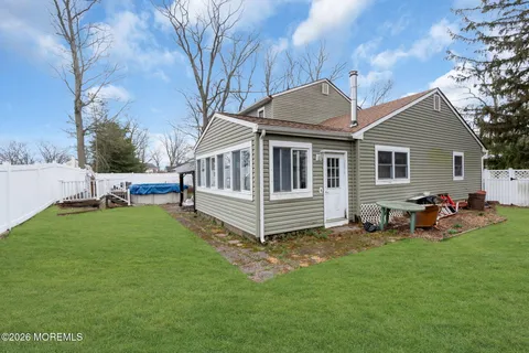 a view of a house with a yard and sitting area