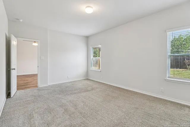 an empty room with windows and closet