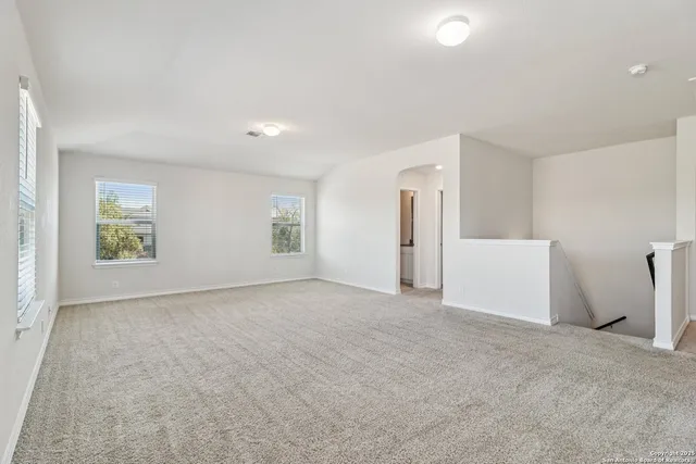 a view of an empty room and a window