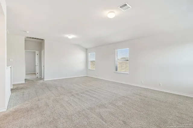an empty room with windows and closet