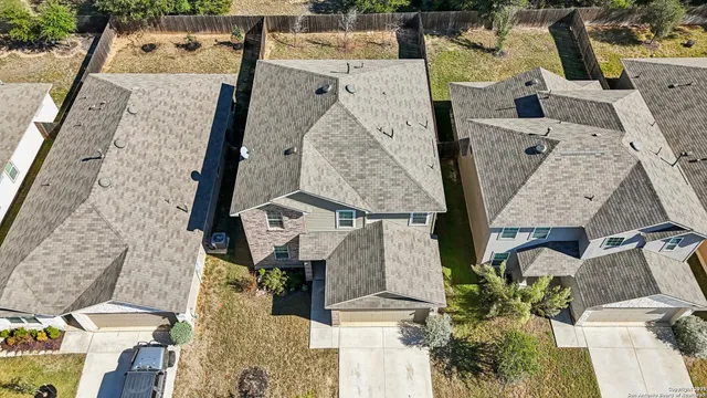 an aerial view of residential houses with outdoor space