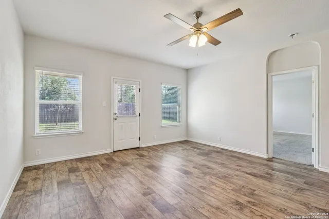 wooden floor in an empty room with a window