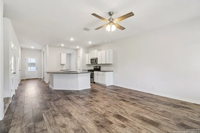 a view of kitchen with cabinets and wooden floor