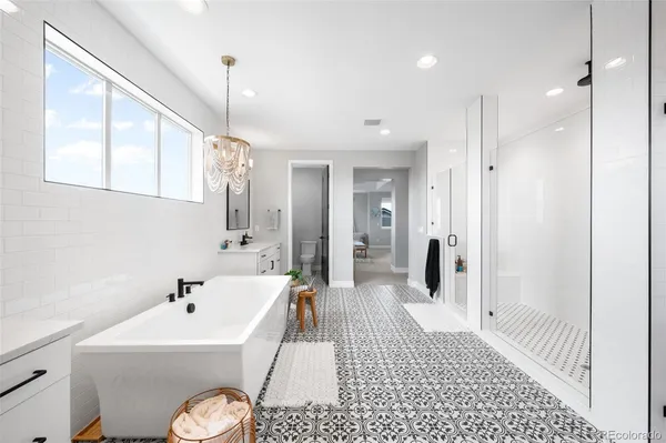 a bathroom with a sink a toilet a mirror and shower