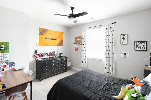 a bedroom with a bed and a dresser in it