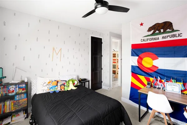 a bedroom that has a bed and a dresser in it