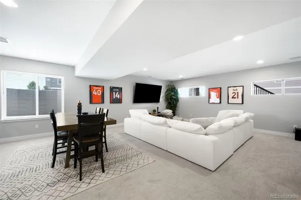 a living room with furniture a rug and a flat screen tv