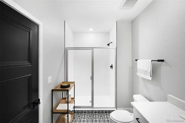 a bathroom with a toilet and a shower