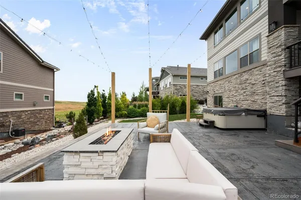 a view of a patio with couches chairs and a fire pit