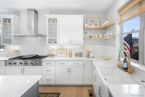 a kitchen with stainless steel appliances granite countertop a sink stove and cabinets