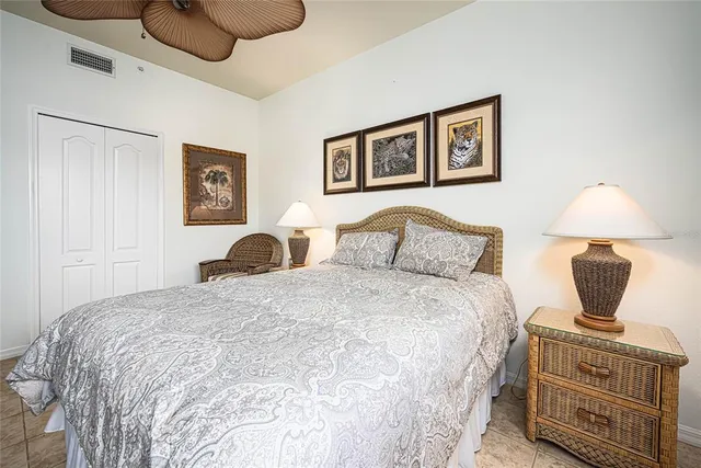 a bedroom with a bed and lamp with on the wall