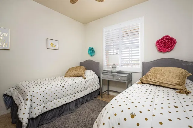 a bedroom with two beds and a window