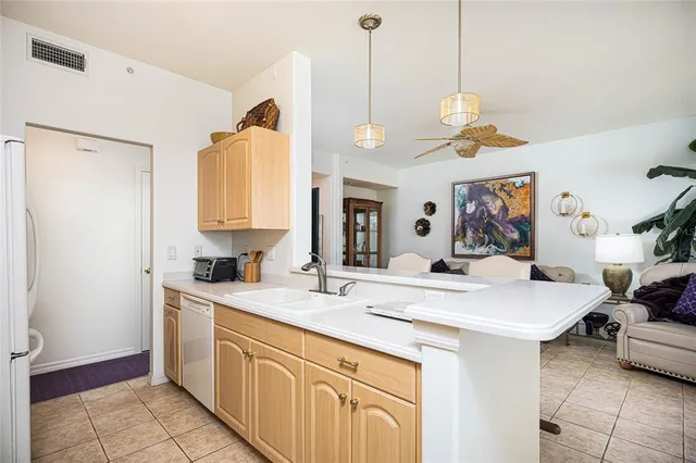 a view of a kitchen area with furniture and wooden floor