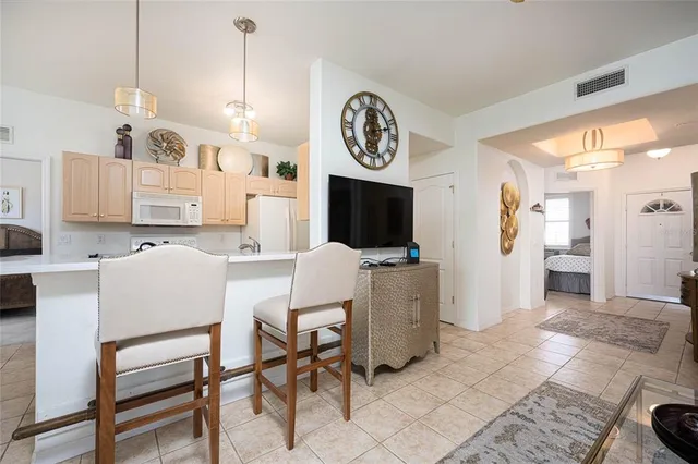a view of kitchen with cabinets and window