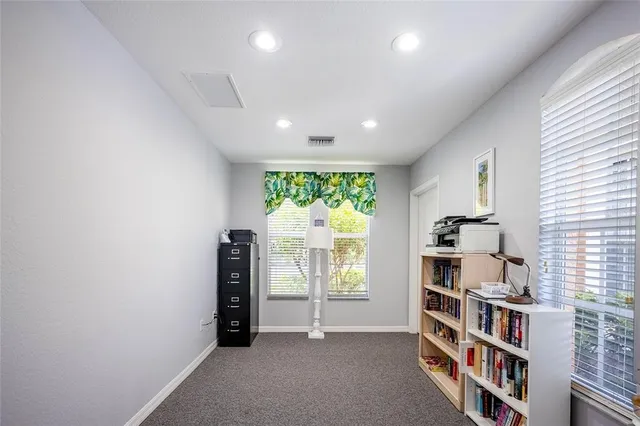 an empty room with bookshelf and a window