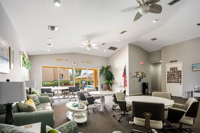 a living room with lots of furniture and a large window