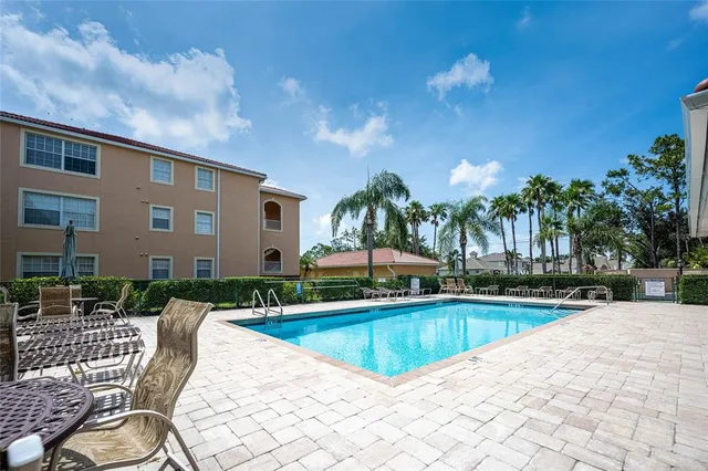 a view of a house with swimming pool and sitting area
