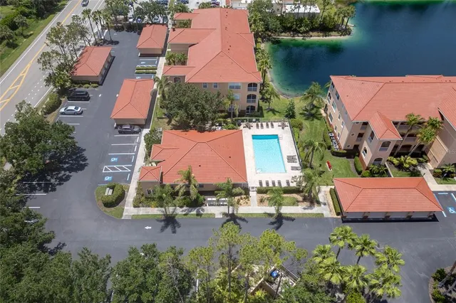 an aerial view of residential houses with outdoor space and lake view